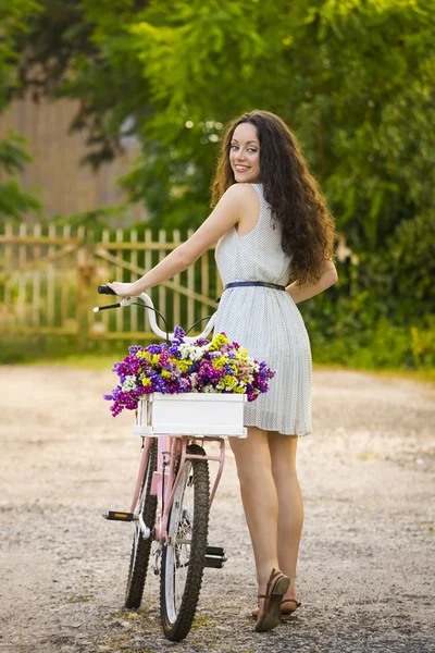 Happy girl with her bicycle — Stock Photo, Image