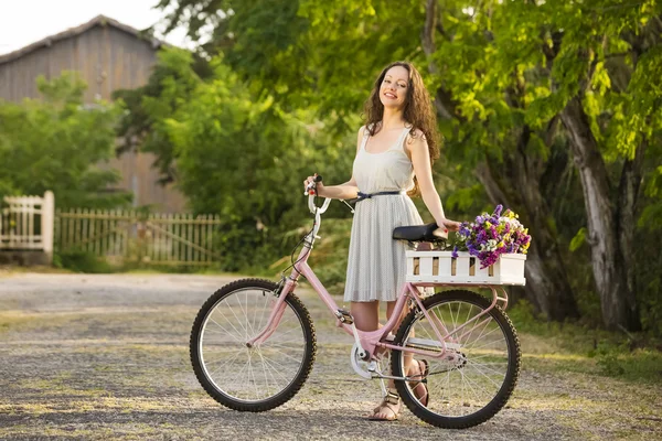 Happy girl with her bicycle — Stock Photo, Image