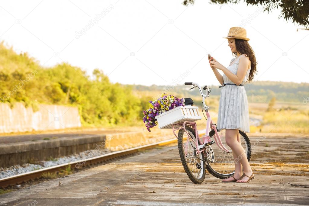 Happy girl with her bicycle