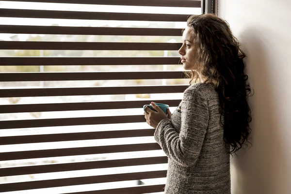 Thoughtful young girl drinking coffee — Stock Photo, Image