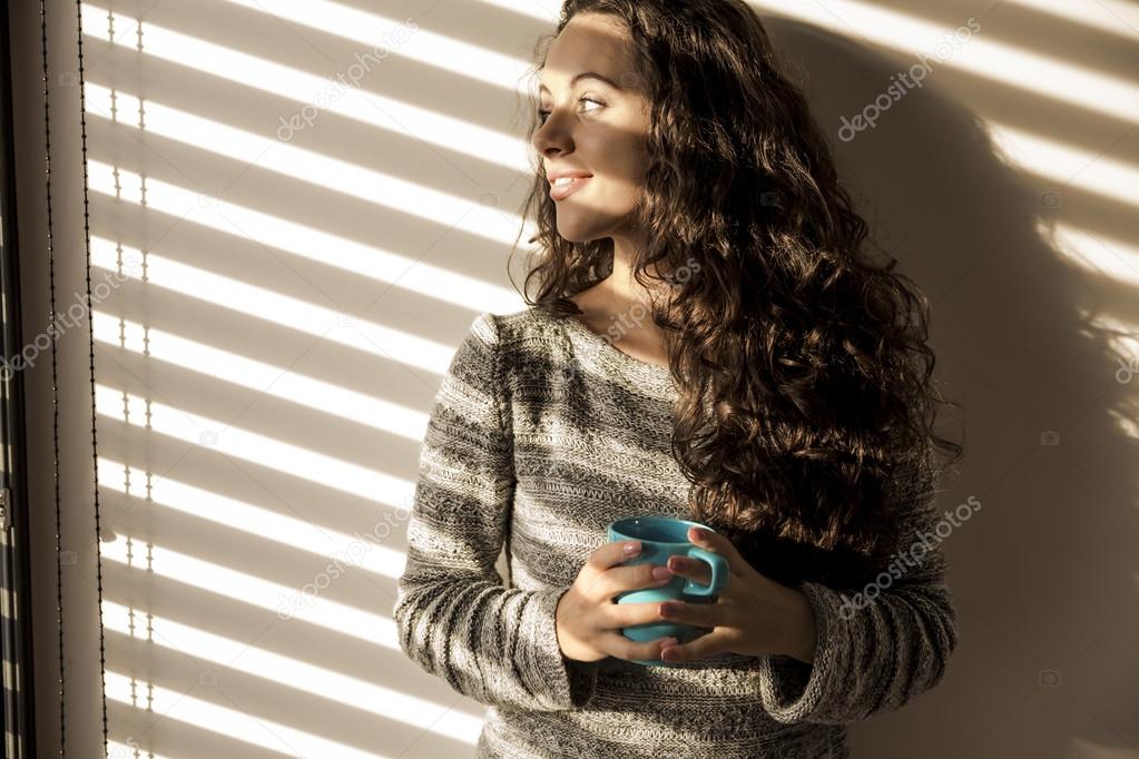 Thoughtful young girl drinking coffee