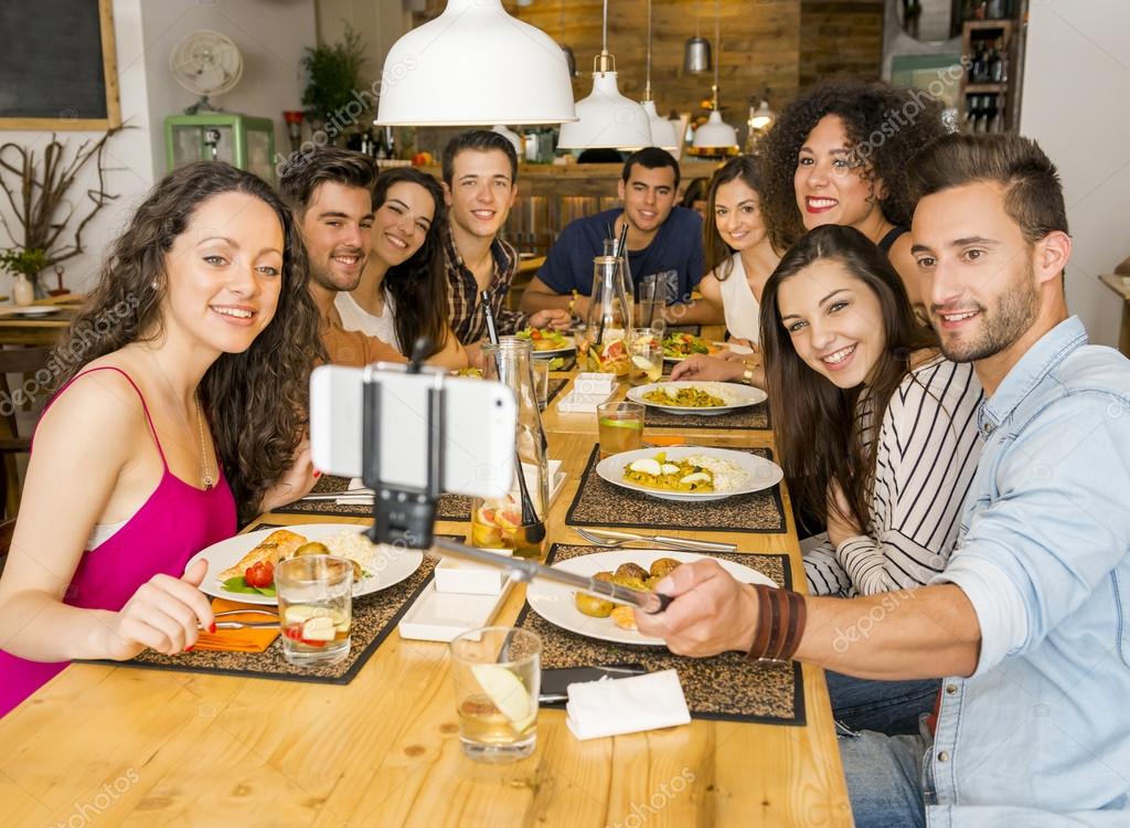 Friends at the restaurant making a selfie — Stock Photo © ikostudio