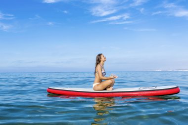 Kadın kürek sörf tahtası üzerinde rahatlatıcı