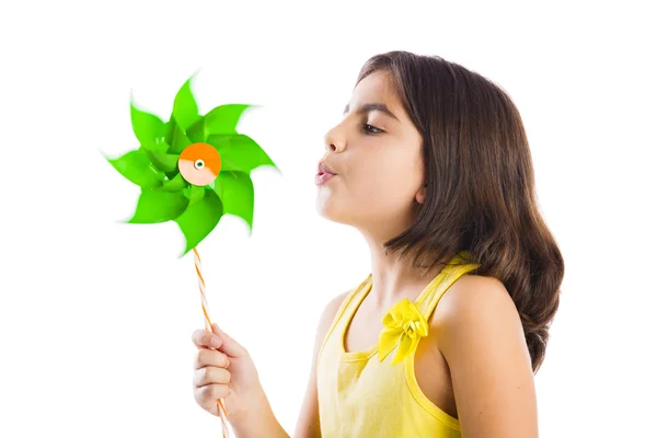 Girl blowing a windmill — Stock Photo, Image