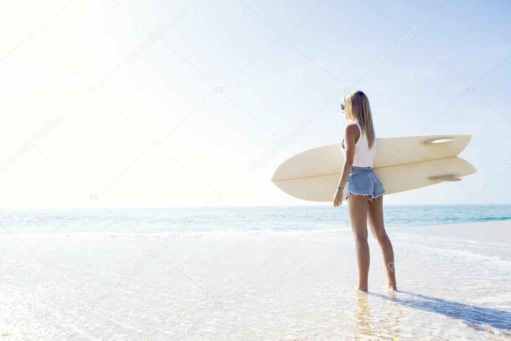 Surfer girl checking the waves