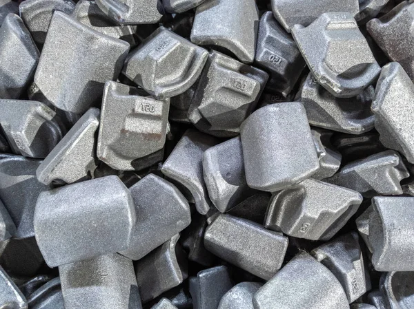 Heap of gray steel forgings after shot blasting - close-up natural heavy industrial pattern with selective focus — Stock Photo, Image