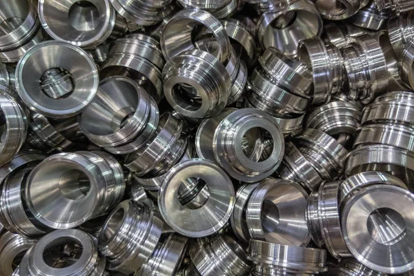 Pile of shiny metal aerospace parts production - close-up with selective focus for full frame industrial background — 图库照片