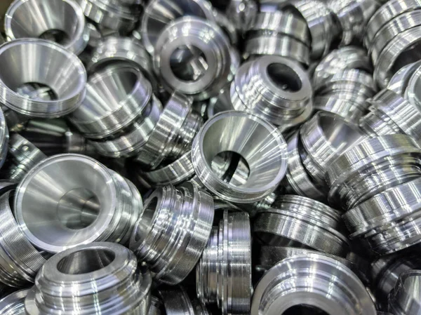 Pile of shiny metal aerospace parts production - close-up with selective focus for full frame industrial background — Stock Photo, Image