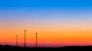 communication towers far on sunrise sky background clipart