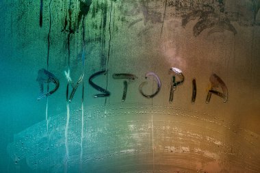 the word dystopia handwritten on wet window glass surface clipart