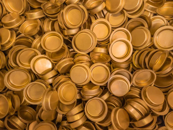 Pile of stamped thin sheet brass hat-shaped semimanufatures — Stock Photo, Image