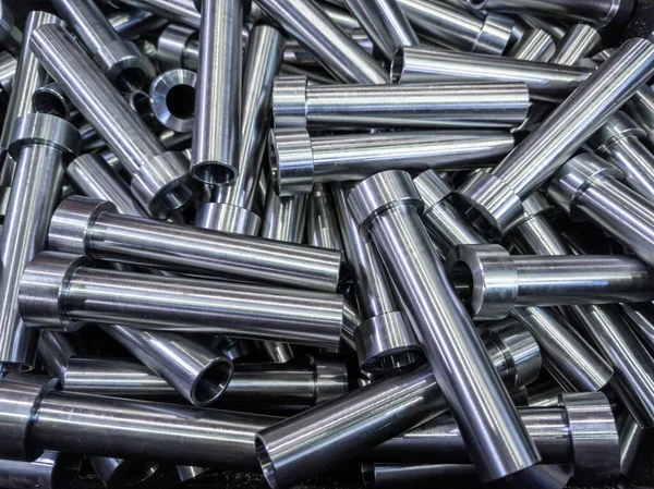 Pile of shiny steel tubes after cnc turning operations - abstract full frame indistrial background — Stock Photo, Image