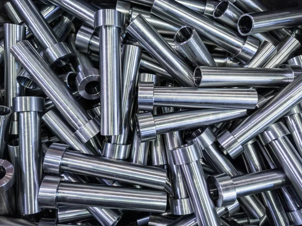 Pile of shiny steel tubes after cnc turning operations - abstract full frame indistrial background — Stock Photo, Image