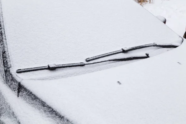 Bil vindruta och torka vattenbladen frysta och täckta med snö på vintern molnigt dagsljus — Stockfoto