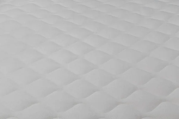 Zachte witte matras close-up achtergrond met selectieve focus. — Stockfoto
