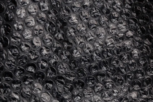 Dark air bubble wrap - valós élet közelkép textúra és háttér — Stock Fotó