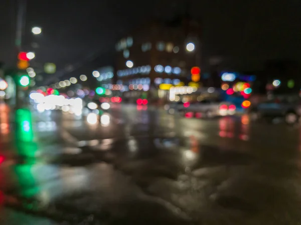 defocused night rain city street cross roads view