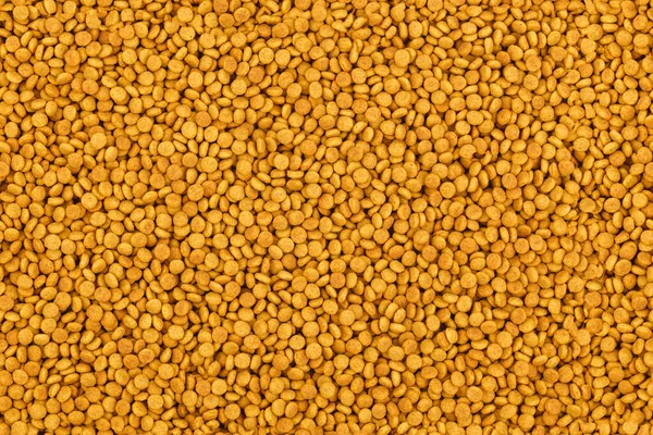 Πλήρες πλαίσιο φόντο μια απρόσκοπτη υφή των μικρών ξηρών πορτοκαλί κροκέτες γάτα τροφίμων — Φωτογραφία Αρχείου