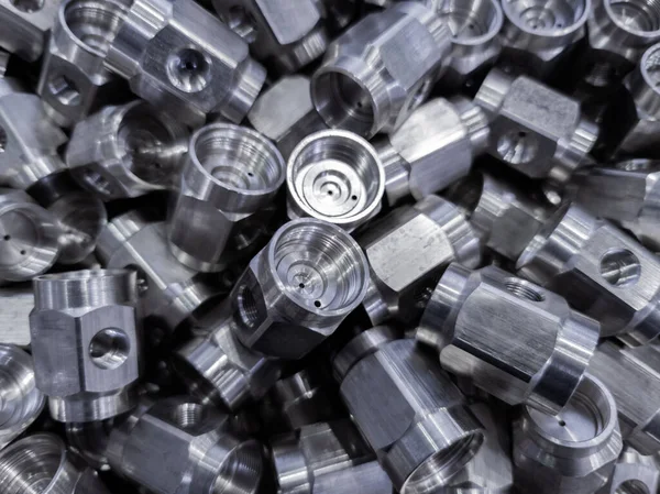 Pile of abstract industrial close-up full frame background of shiny steel turned hexagonal parts — Stock Photo, Image