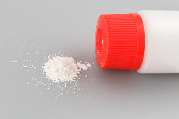 White plastic bottle of baby powder on gray background — Stock Photo, Image