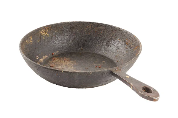 Oud walgelijk gebeitst roestig gietijzeren pan met verbrand vet en voedsel restjes geïsoleerd — Stockfoto