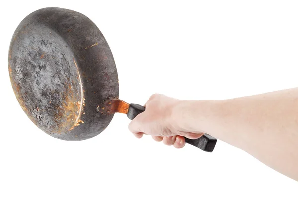 Bare caucasian hand holding empty old cast iron frying pan — Stock Photo, Image