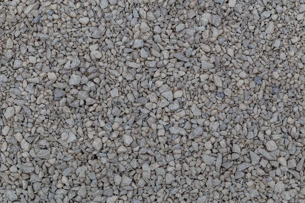 Dry white limestone ballast flat full frame background. Small gray dusty broken macadam stones texture. — Stock Photo, Image