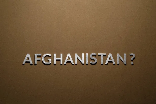 A questão afeganistão colocado com letras de metal de prata em tecido de lona cáqui bronzeado áspero — Fotografia de Stock