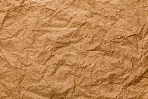 Ragged crumpled brown kraft paper texture and full frame background — Fotografia de Stock