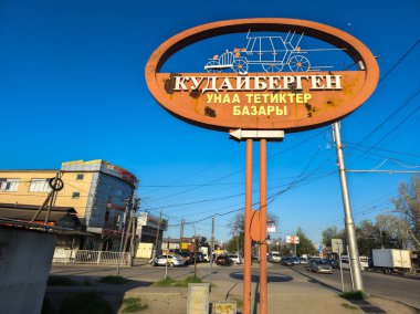 old sign Kudaibergen automotive bazaar at sunny day in Bishkek, Kyrgyzstan - April 18, 2024