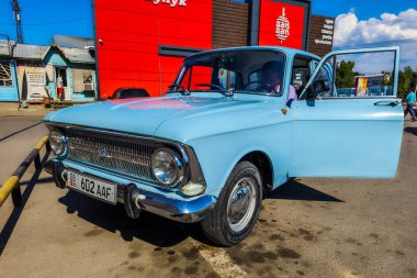 A classic light blue IZh 412 car parked outdoors in Sokuluk, Kyrgyzstan - July 12, 2024