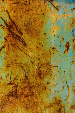 Close-up of a blue metal surface with deep scratches revealing extensive rust and yellowing, showing significant wear