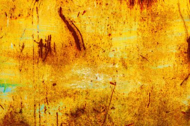 Yellow painted metal surface with significant rust patches and faint blue paint remnants.