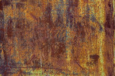 Rusty multicolored metal texture in brown-yellow tones with layers of different colors due to corrosion and weathering, creating a textured, aged surface with a grunge aesthetic.