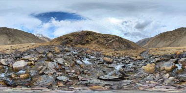 A 360 by 180 degrees equirectangular panorama of Mountain river with boulders at springtime in mountain gorge at sunny afternoon