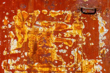 Close-up of a heavily rusted metal surface with significant areas of flaking and peeling red paint, revealing the underlying corrosion.