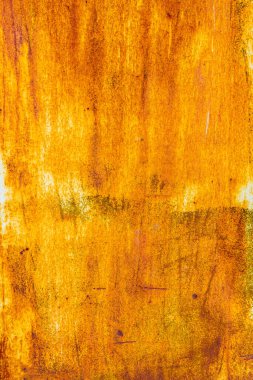 Extensive rust on a metal surface with vertical white paint leftovers and dark corrosion spots