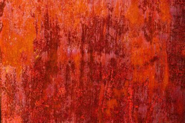 Uniformly rusted reddish-brown metal surface with vertical streaks of darker oxidation