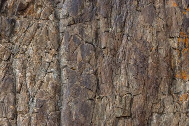 Dağlık Kırgızistan bölgesinde gündüz boyunca engebeli, detaylı tortulu kaya oluşumu - doku ve tam kare yakın plan