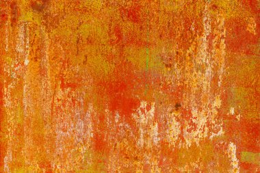 Close-up of a weathered rusty metal surface with a vibrant orange and yellow texture. The corroded iron shows peeling paint and oxidation, creating an abstract industrial background with a rough, aged appearance.