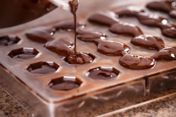 Putting chocolate in mold — Stock Photo, Image