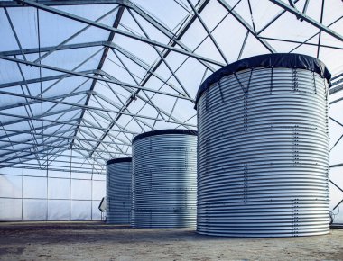 Three water storage tank in a warehouse, industrial concept clipart