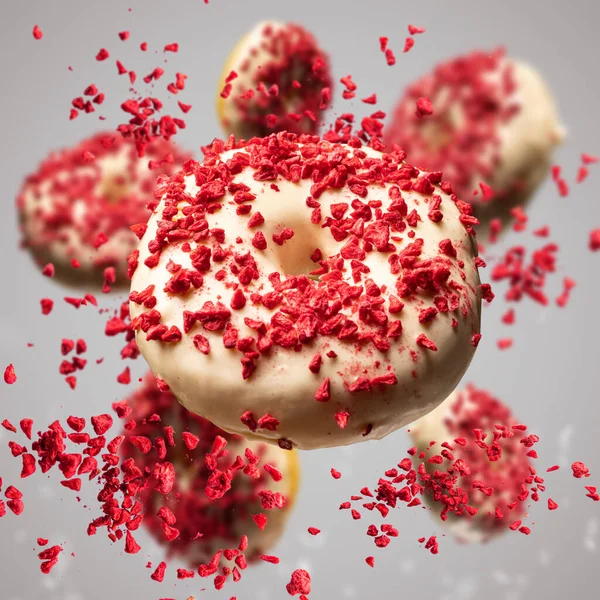 Flying Donuts Glazed White Chocolate Decorated Lyophilized Strawberries Red Background — Stock Photo, Image