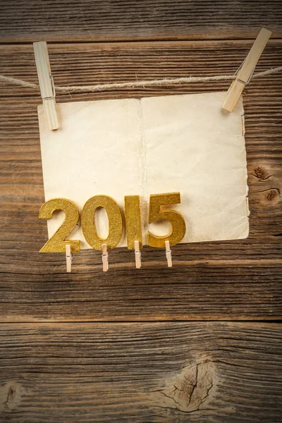 Paper and 2015 golden figures — Stock Photo, Image