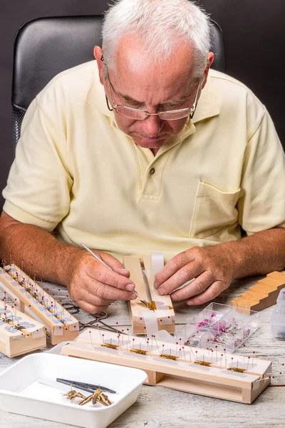 Elderly man spread a butterfly wings — Stock Photo, Image