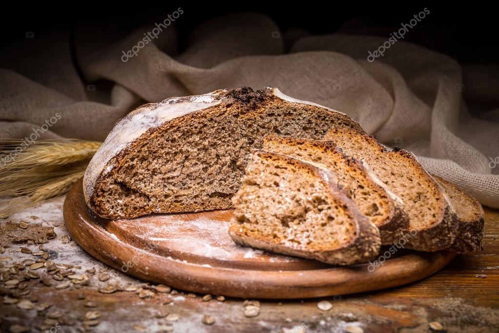 Sourdough bread slicing Stock Photo by grafvision