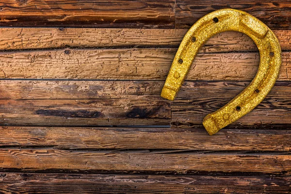 Golden horseshoes on wooden — Stock Photo, Image