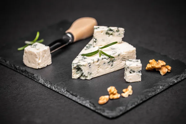 Blue cheese on black slate — Stock Photo, Image