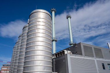 Cogeneration plant in front of a blue sky  clipart