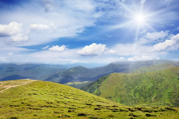 Altas montañas y sol en el cielo azul —  Fotos de Stock